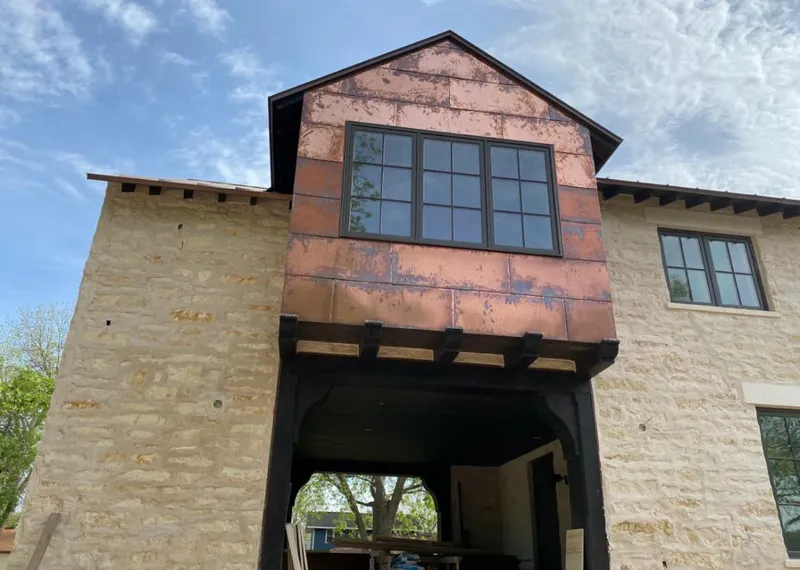 Copper metal panel facade on a stone building for Skylight Installation in Raisinville