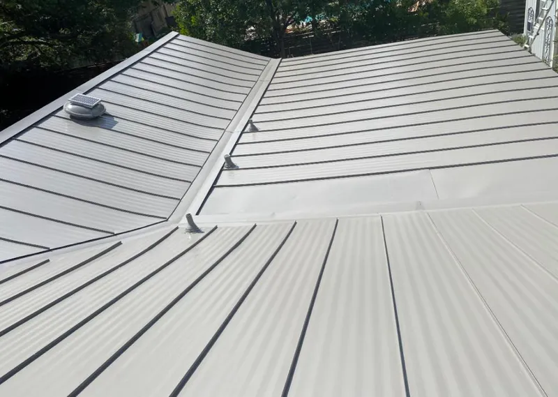 Solar attic fan installed on a metal roof for Roof Ventilation in Raisinville